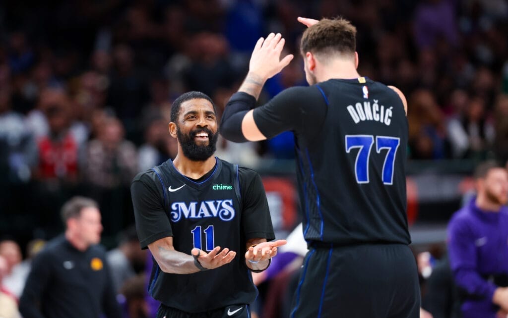 Dallas Mavericks guard Luka Doncic high fives guard Kyrie Irving.