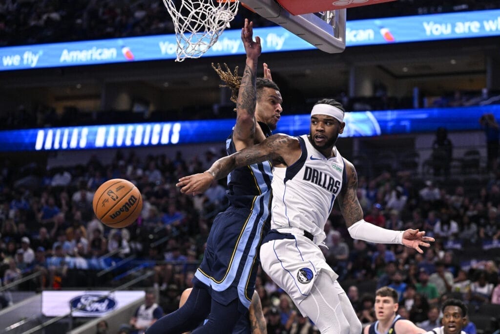 Dallas Mavericks guard Jaden hardy makes a pass against a defender.