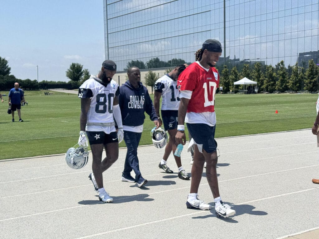 New Dallas Cowboys QB Joe Milton (red jersey) walks after practice on May 29, 2025 at The Star in Frisco. (Joseph Hoyt/Staff)