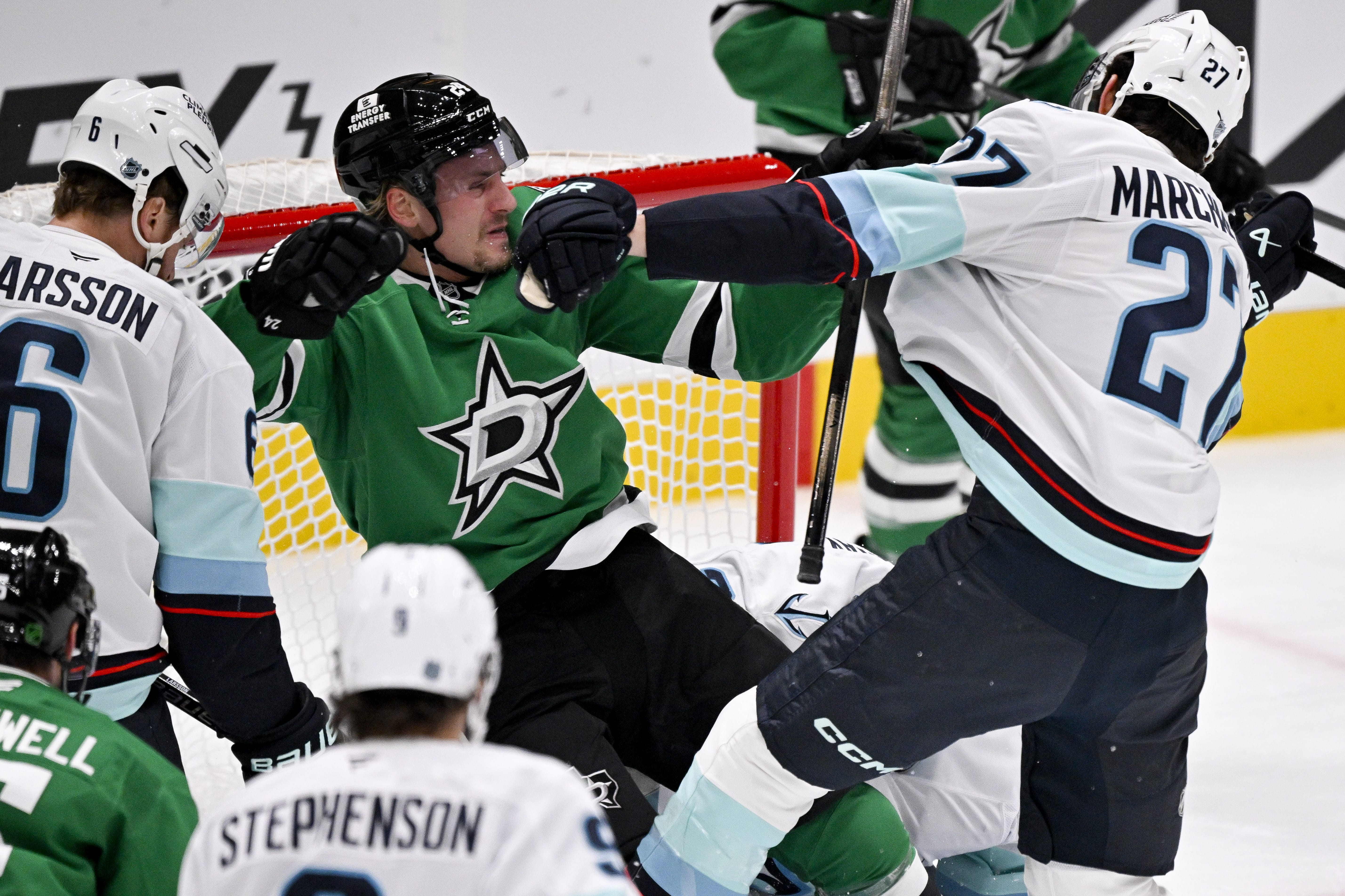 Seattle Kraken forward Mason Marchment hits Dallas Stars forward Roope Hintz