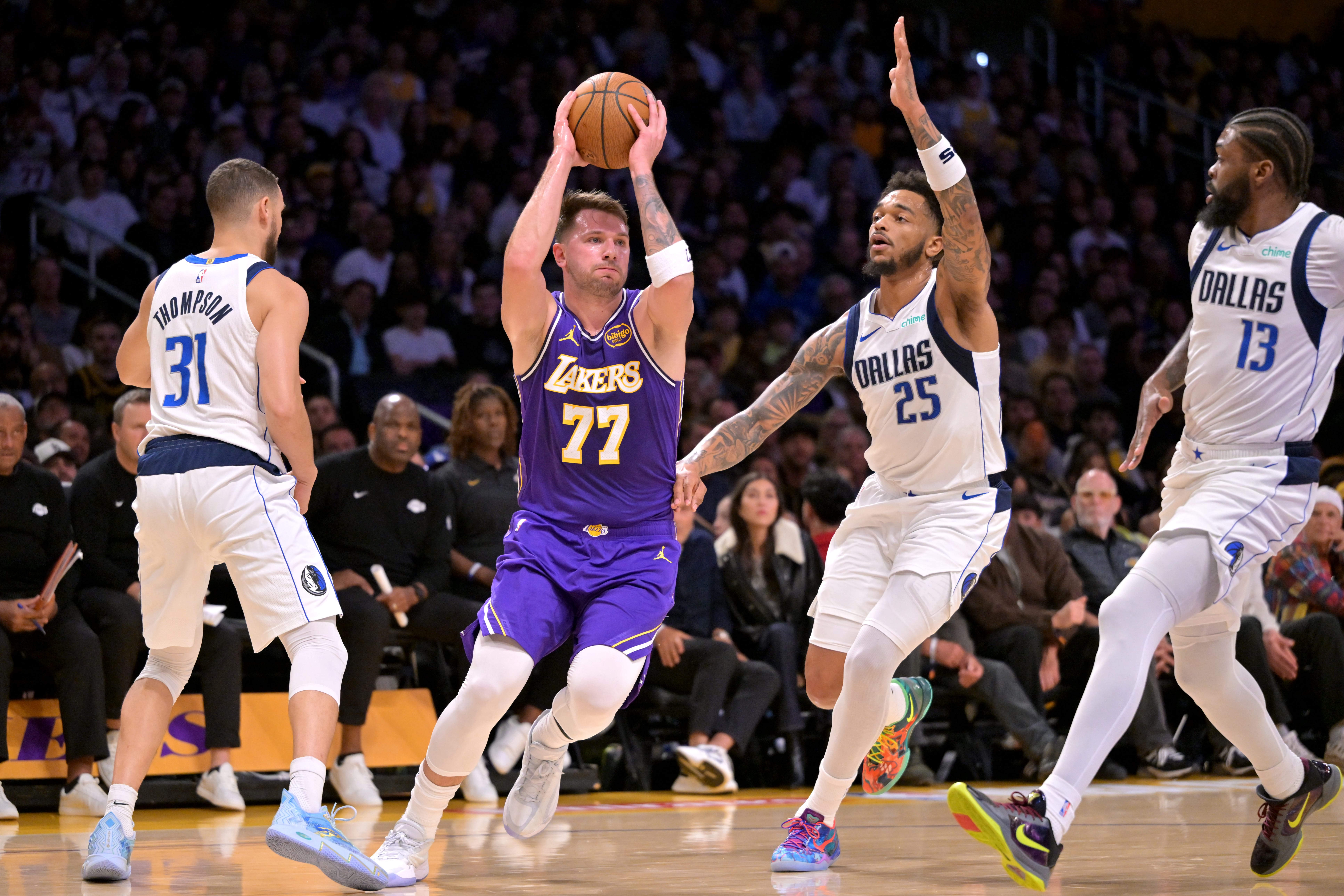 Lakers' Luka Doncic being guarded by three Mavericks