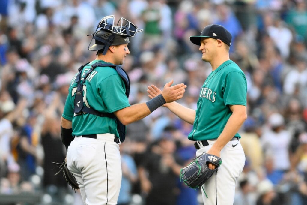 Former Seattle Mariners/now Arizona Diamondbacks closer Paul Sewald greets his catcher after converting a save.