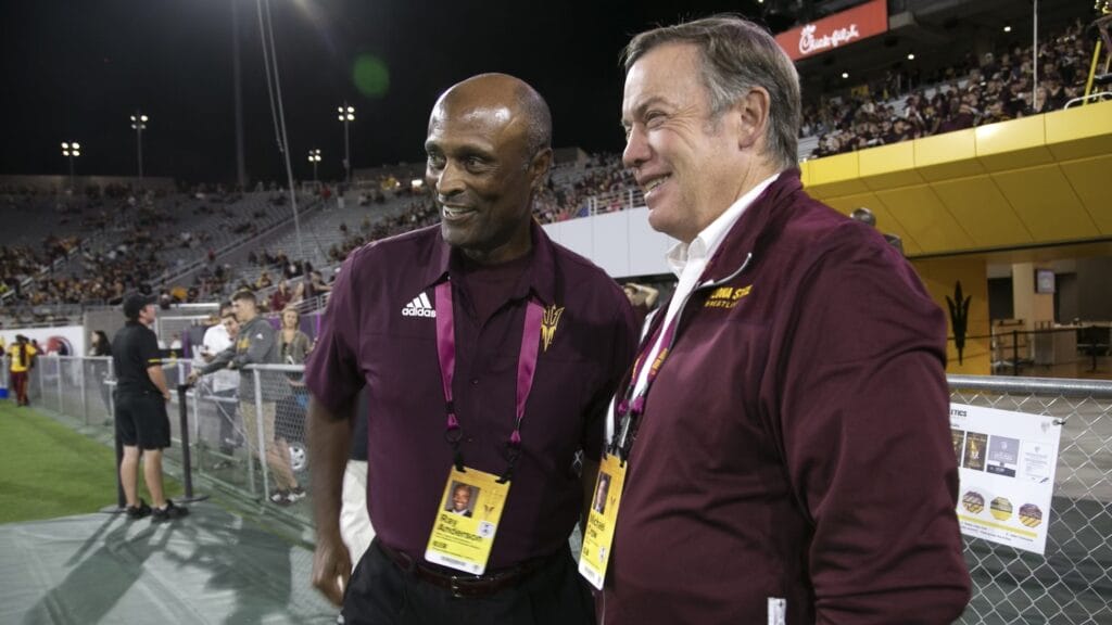 Sun Devils athletic director Ray Anderson and ASU president Michael Crow share a laugh during an ASU football game.