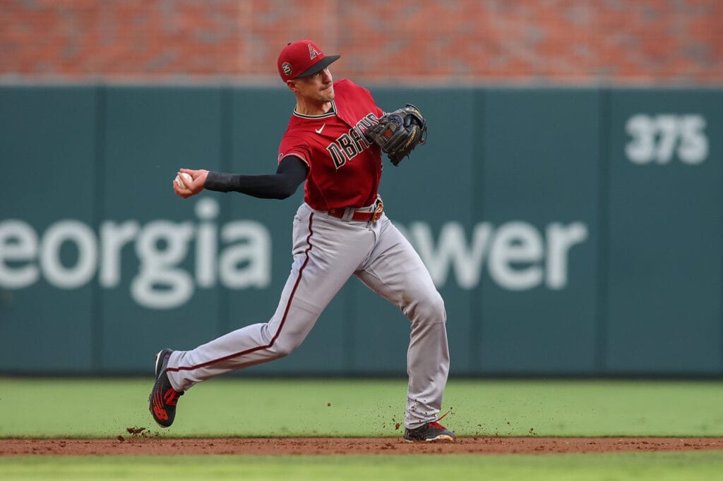 Diamondbacks shortstop Nick Ahmed throws a runner out at first base.