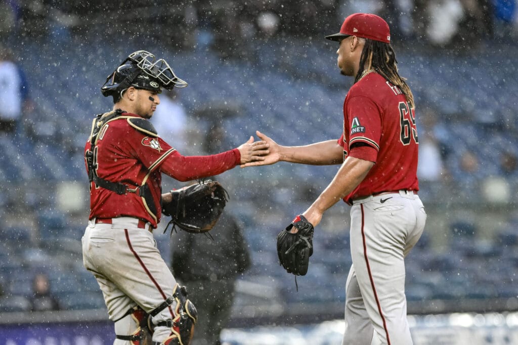 Diamondbacks pitcher Luis Frías and catcher Gabriel Moreno greet after a soggy Diamondbacks win at Yankee Stadium.