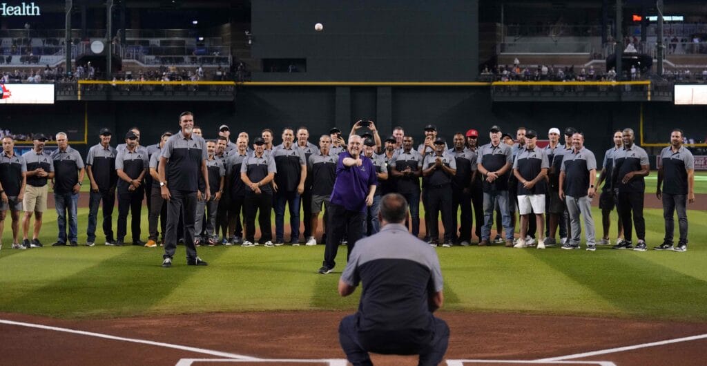 Diamondbacks broadcaster Greg Schulte throws out the first pitch amidst former Arizona Diamondbacks players during the 25th anniversary celebration at Chase Field. (Joe Camporeale/USA TODAY Sports)