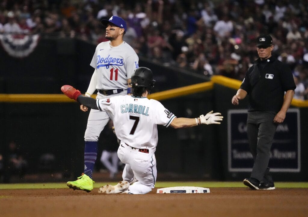 Diamondbacks outfielder Corbin Carroll steals second base against the Los Angeles Dodgers during Game 3 of the NLDS at Chase Field.