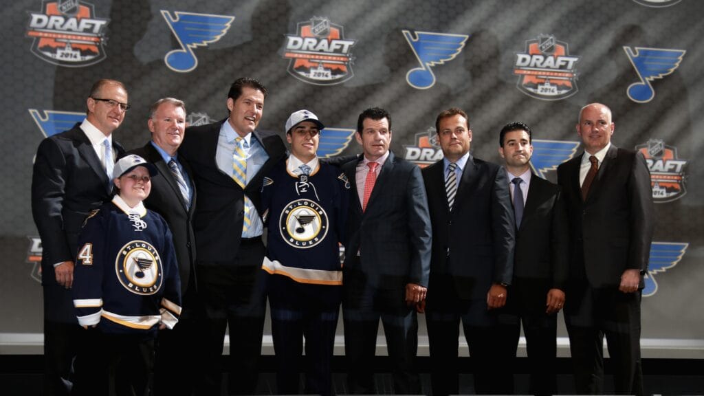 Bill Armstrong (fourth from left) and Doug Armstrong (far right) oversaw many drafts in their time together in St. Louis before Bill became Coyotes GM.