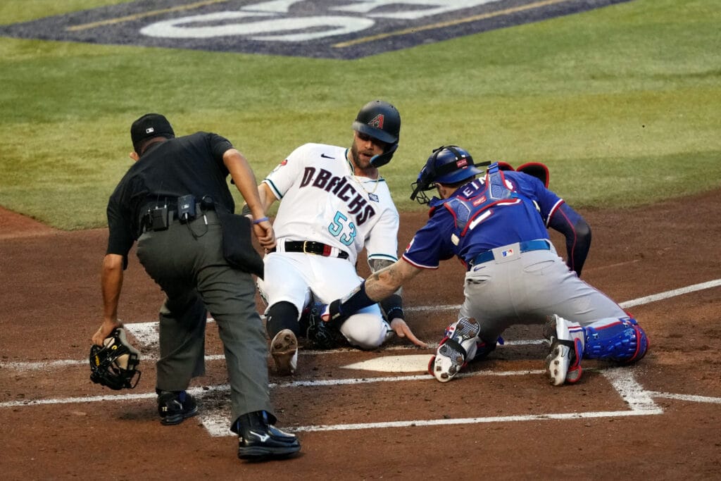 Arizona Diamondbacks first baseman Christian Walker (53) is out at home against Texas Rangers catcher Jonah Heim (28) in the second inning in game three of the 2023 World Series at Chase Field. Mandatory Credit: Joe Camporeale-USA TODAY Sports