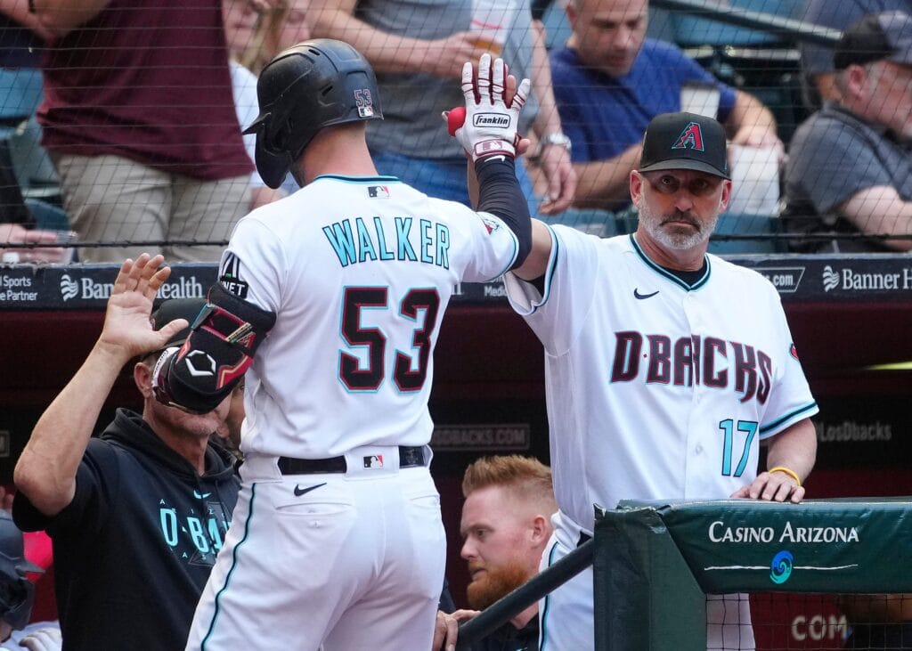 Diamondbacks manager Torey Lovullo (R) greets Christian Walker (53) and Corbin Carroll (7) after a Walker two-run home run against the Padres in the third inning during a game at Chase Field on April 22, 2023.