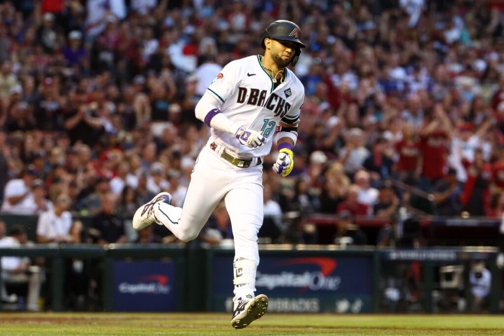 Diamondbacks left fielder Lourdes Gurriel Jr. (12) runs to first base after hitting a single against the Texas Rangers during the second inning in game five of the 2023 World Series at Chase Field.