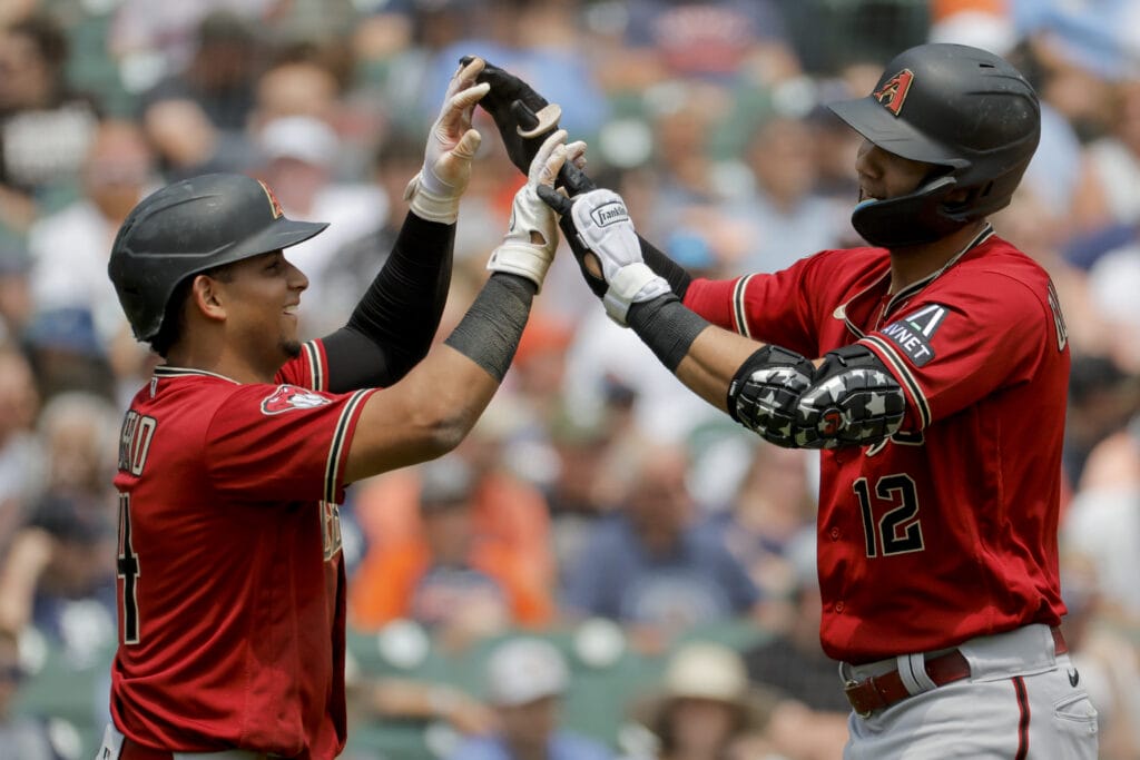 Arizona Diamondbacks designated hitter Lourdes Gurriel Jr. (12) is congratulated by catcher Gabriel Moreno (14) after hitting a three-run home run in the fifth inning against the Detroit Tigers at Comerica Park.