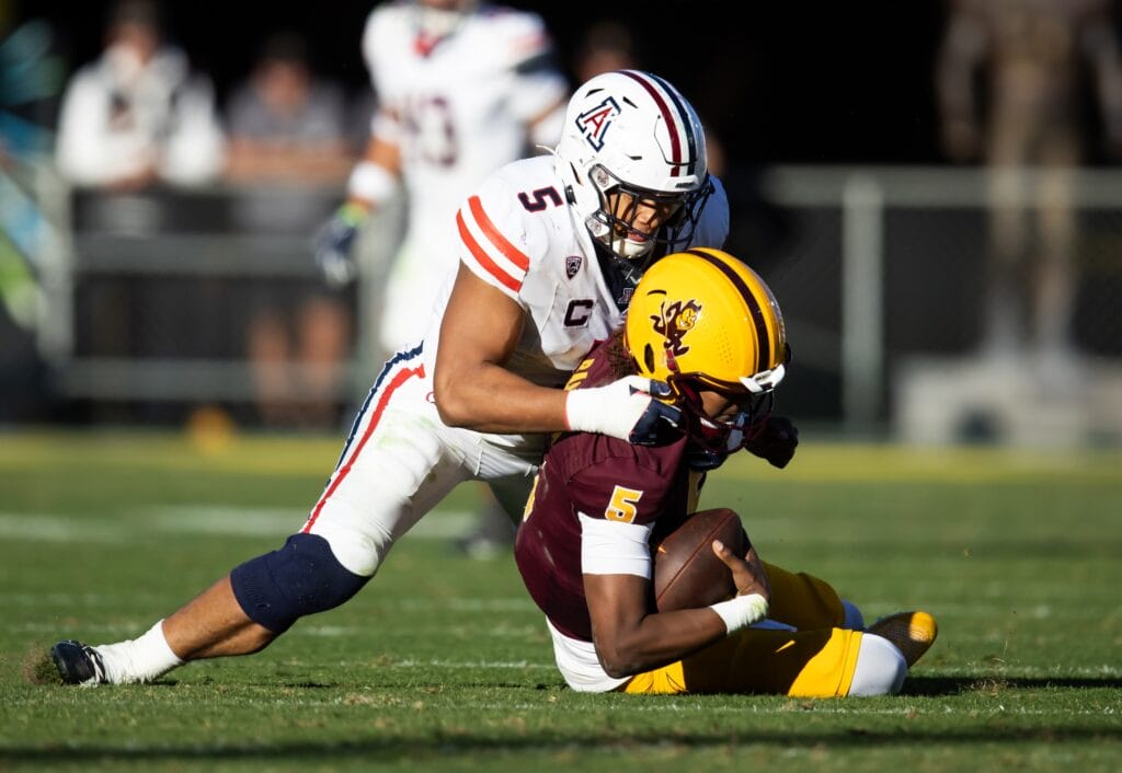 Arizona Wildcats linebacker Jacob Manu sacks Arizona State quarterback Jaden Rashada in 2023. (Mark J. Rebilas-USA TODAY Sports)