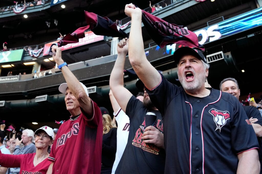 Fans cheer in the stands before game four of the 2023 World Series between the Texas Rangers and the Arizona Diamondbacks at Chase Field.