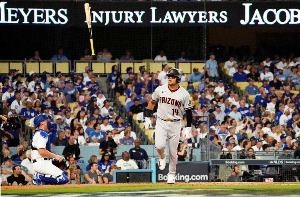 Diamondbacks Gabriel Moreno (14) flips his bat high into the air after hitting a three run home run off NL West rival Los Angeles Dodgers starting pitcher Clayton Kershaw in the first inning during Game 1 of the NLDS at Dodger Stadium.