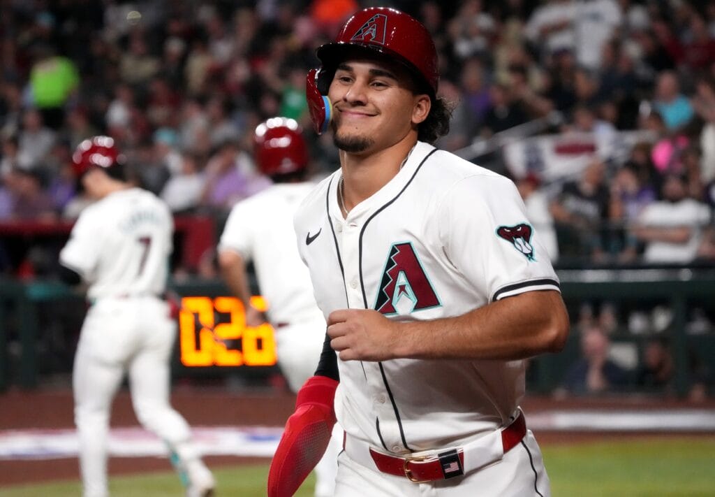 Diamondbacks outfielder Alek Thomas (5) smiles after scoring a run against the Colorado Rockies on Opening Day at Chase Field.