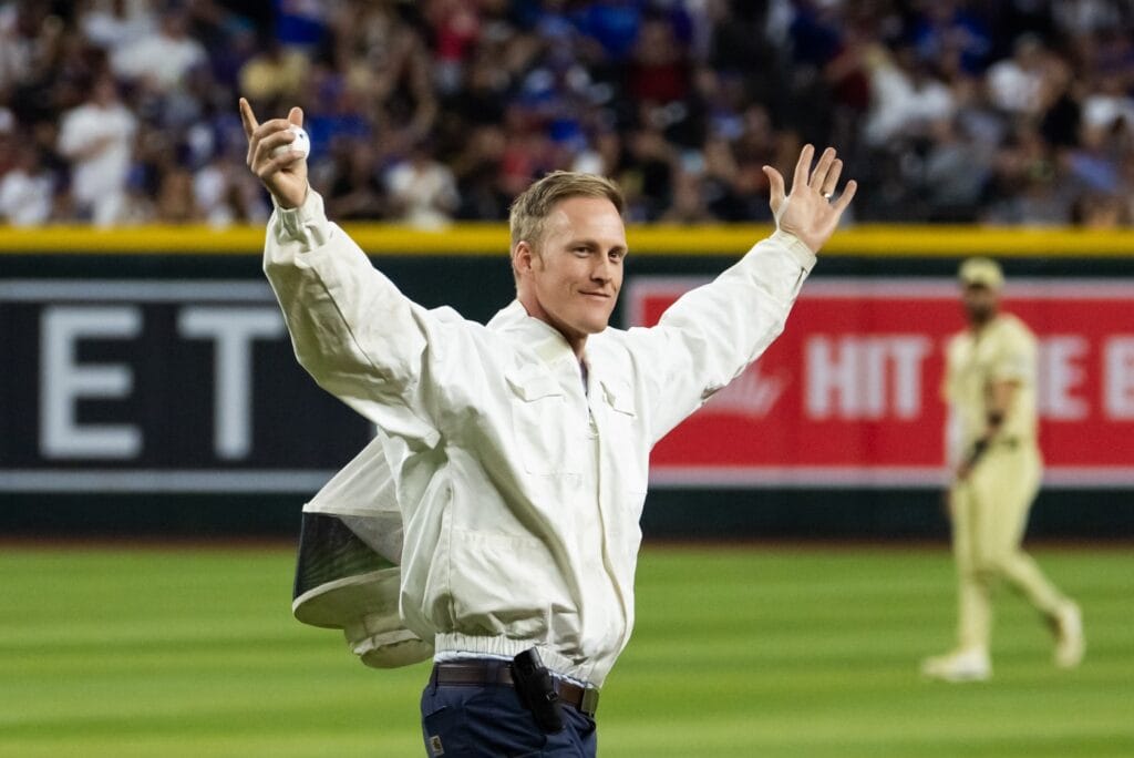Beekeeper Matt Hilton throws out the first pitch prior to the Arizona Diamondbacks game against the Los Angeles Dodgers at Chase Field. Hilton had earlier removed a swarm of bees that had delayed the start of the game.