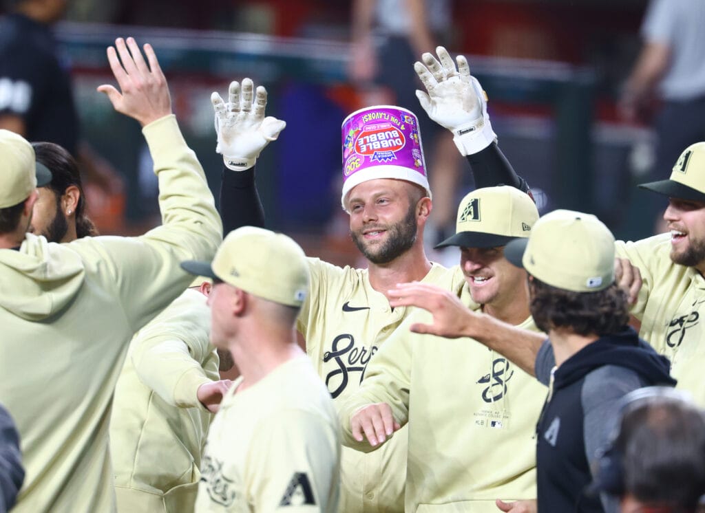 Diamondbacks first baseman Christian Walker celebrates with teammates after hitting a two run walk off home run in the tenth inning against the Los Angeles Dodgers at Chase Field.