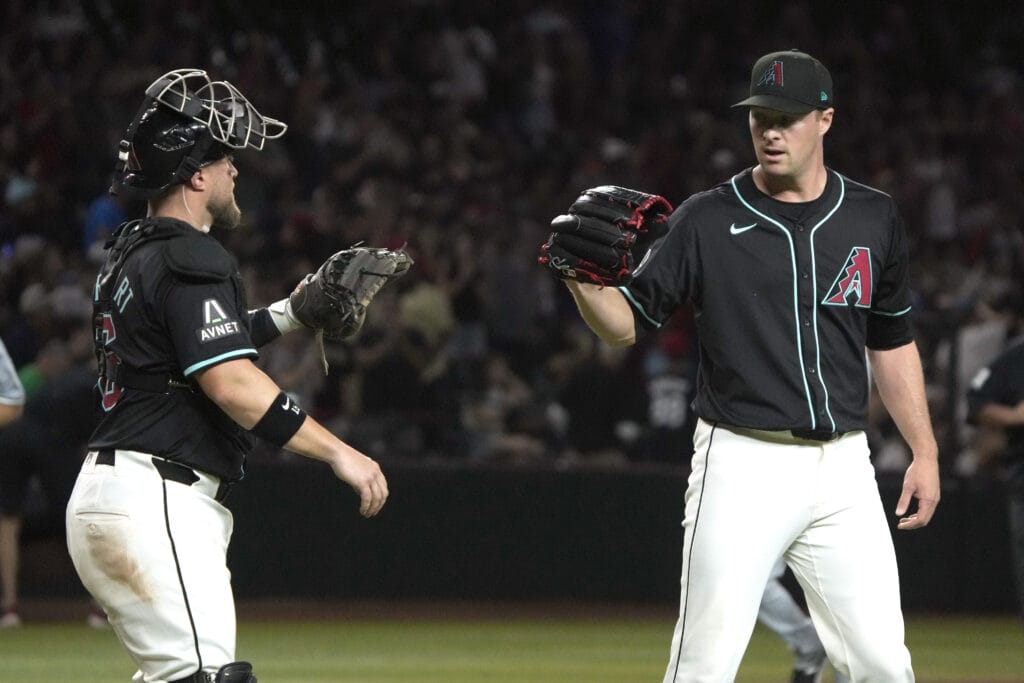 Diamondbacks catcher Tucker Barnhart (16) and pitcher Joe Mantiply (35) celebrate after defeating the Chicago White Sox at Chase Field.