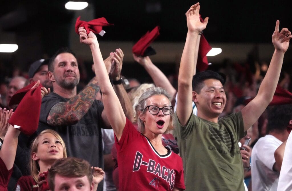 Diamondbacks fans cheer from the stands as Lourdes Gurriel Jr. hits a 2-run home run against the Colorado Rockies on Opening Day at Chase Field.
