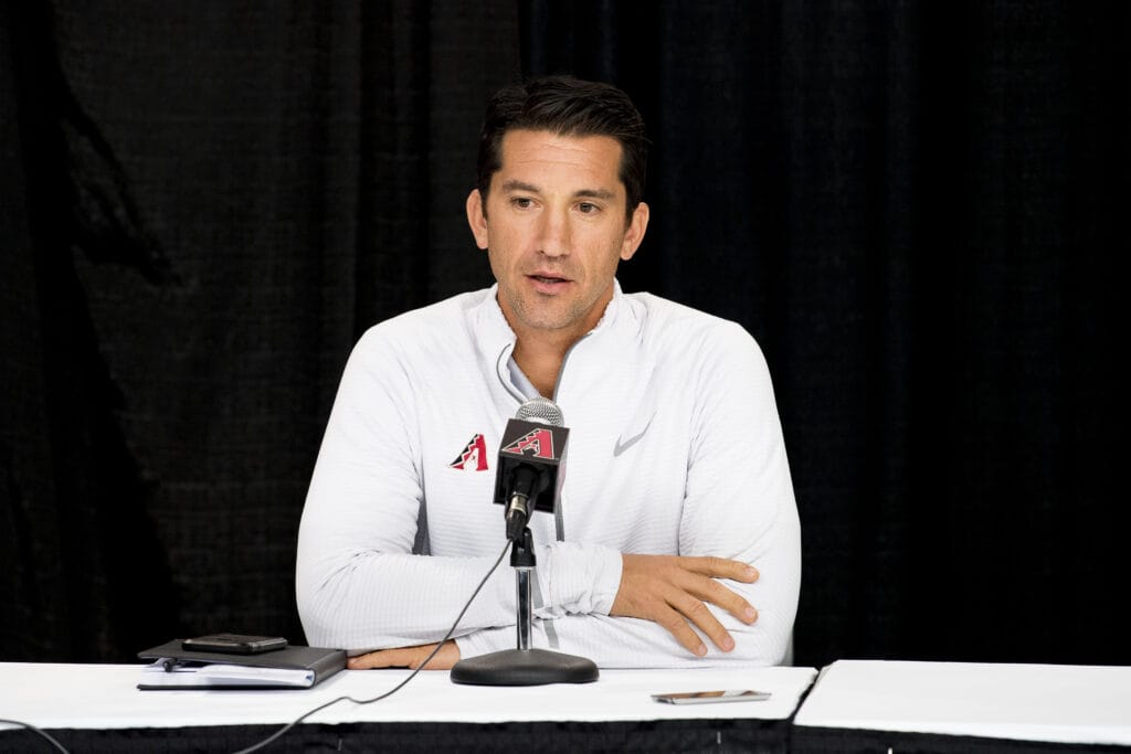 Diamondbacks general manager Mike Hazen sits at a podium.