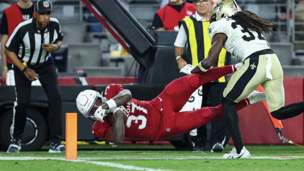 The Cardinals' Tony Jones dives for a touchdown.