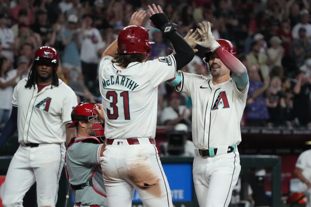 Diamondbacks outfielder Corbin Carroll (7) celebrates with outfielder Jake McCarthy (31) after hitting a two-run home run against the Philadelphia Phillies in the seventh inning at Chase Field.