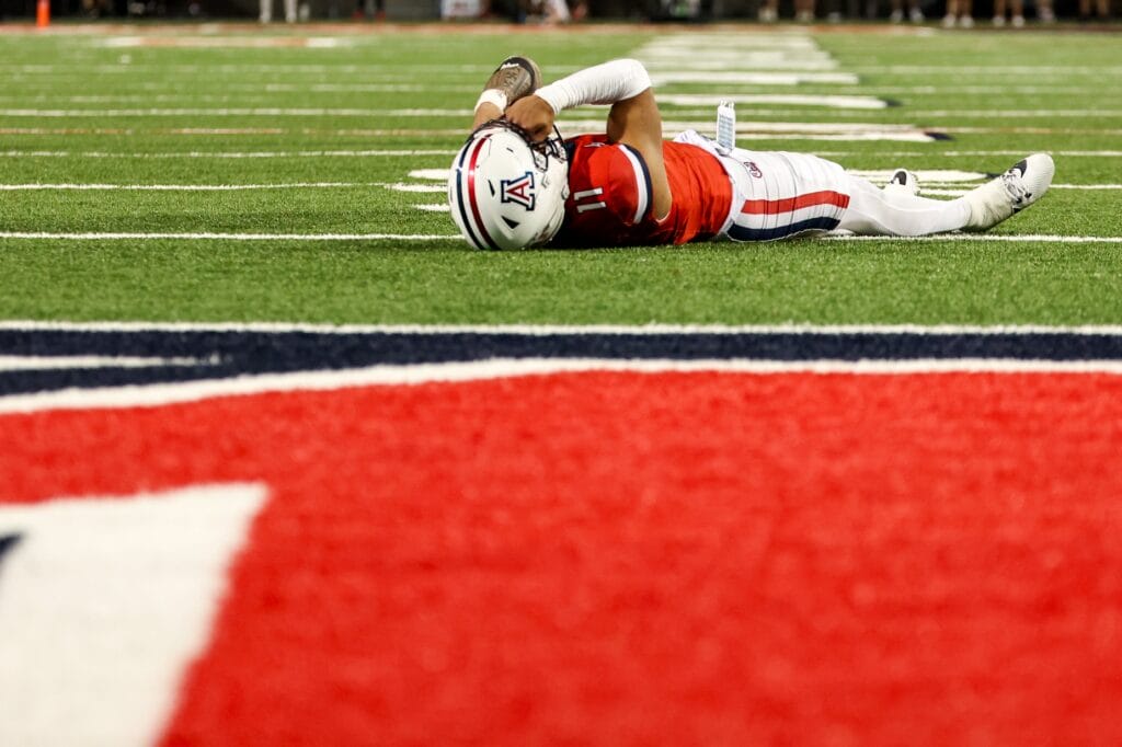 Arizona Wildcats quarterback Noah Fifita lays on ground in disappointment after he fails to catch a pass during the fourth quarter against West Virginia. (Aryanna Frank-Imagn Images)
