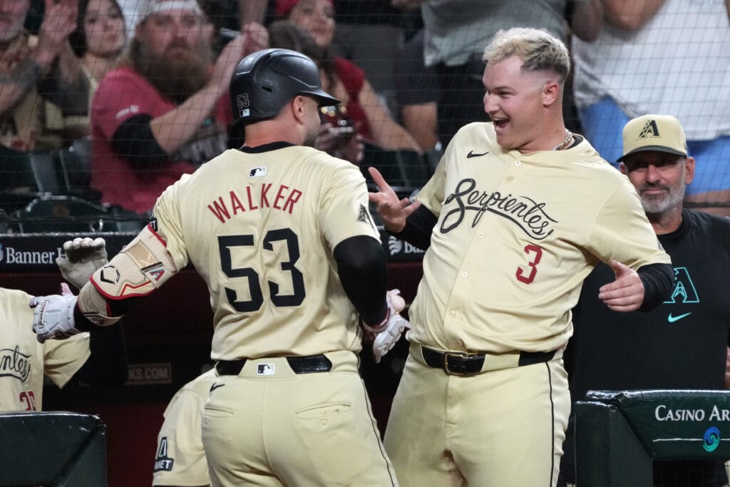 Diamondbacks first base Christian Walker (53) celebrates with Joc Pederson (3) after hitting a solo home run against the Texas Rangers in the first inning at Chase Field.
