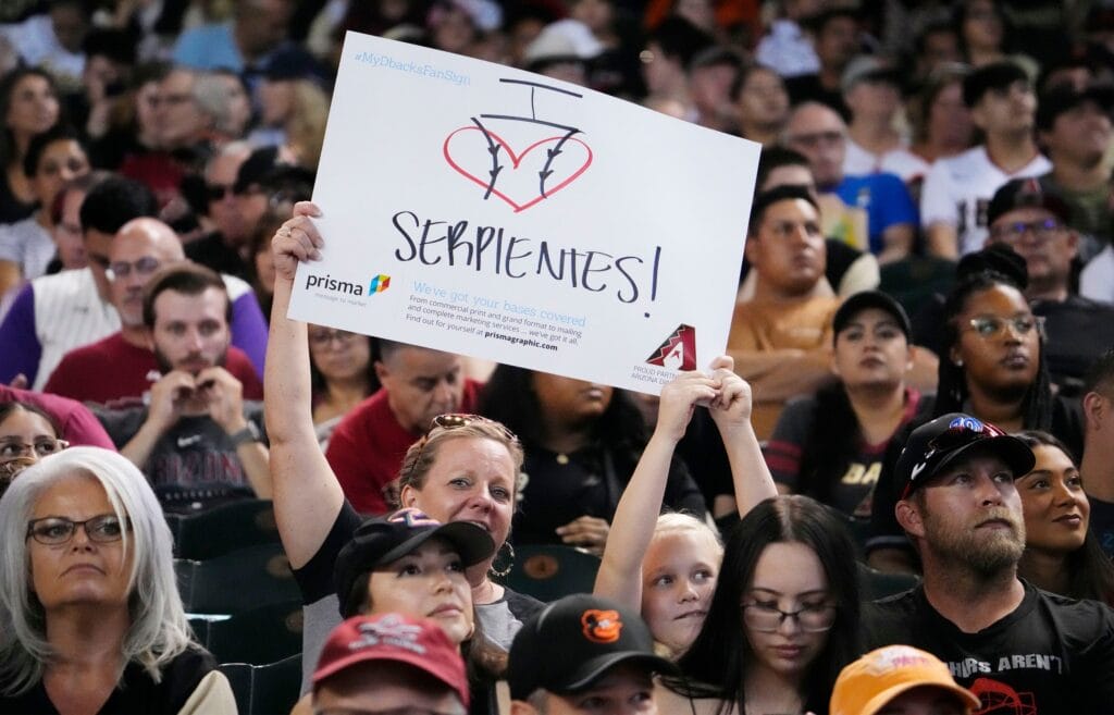 An Arizona Diamondbacks fan holds up a sign during Mexican Heritage Night at Chase Field in Phoenix on Sept. 2, 2023.