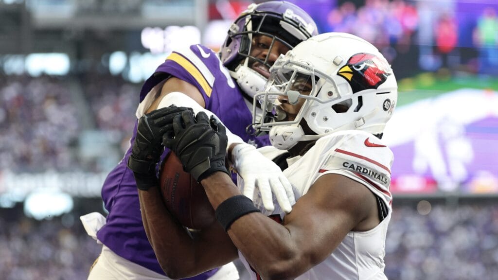 MINNEAPOLIS, MINNESOTA - DECEMBER 01: Marvin Harrison Jr. #18 of the Arizona Cardinals catches a pass in front of Fabian Moreau #23 of the Minnesota Vikings for a touchdown during the third quarter at U.S. Bank Stadium on December 01, 2024 in Minneapolis, Minnesota. (Photo by David Berding/Getty Images)