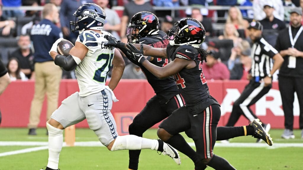 GLENDALE, ARIZONA - DECEMBER 08: Zach Charbonnet #26 of the Seattle Seahawks runs with the ball while being chased by Sean Murphy-Bunting #23 and Starling Thomas V #24 of the Arizona Cardinals in the second quarter at State Farm Stadium on December 08, 2024 in Glendale, Arizona. (Photo by Norm Hall/Getty Images)