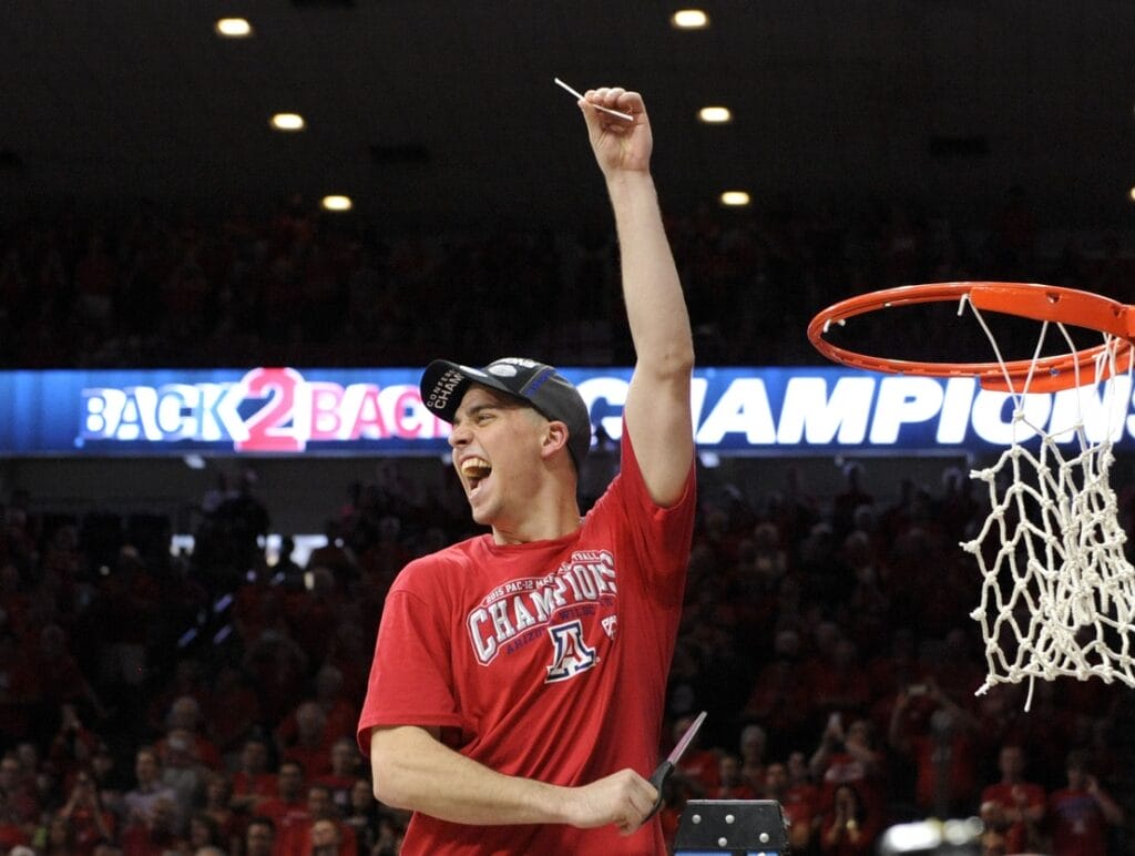 Arizona Wildcats guard T.J. McConnell cuts down the net after Arizona won the 2015 Pac-12 regular-season title. (Casey Sapio-USA TODAY Sports)