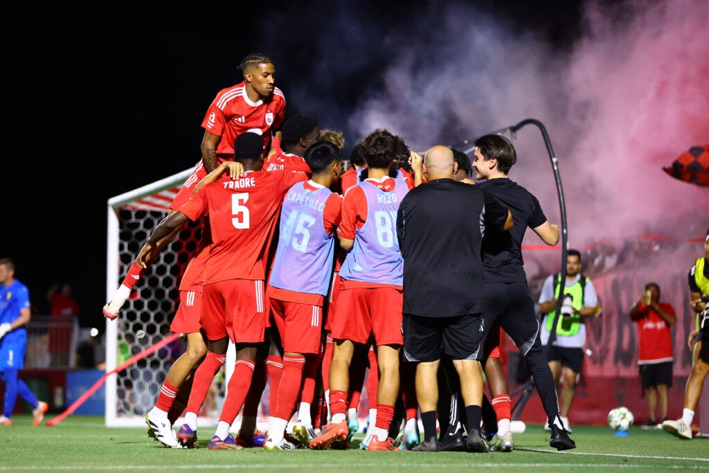 Multiple Phoenix Rising players celebrate a penalty shoot-out win over New Mexico United.