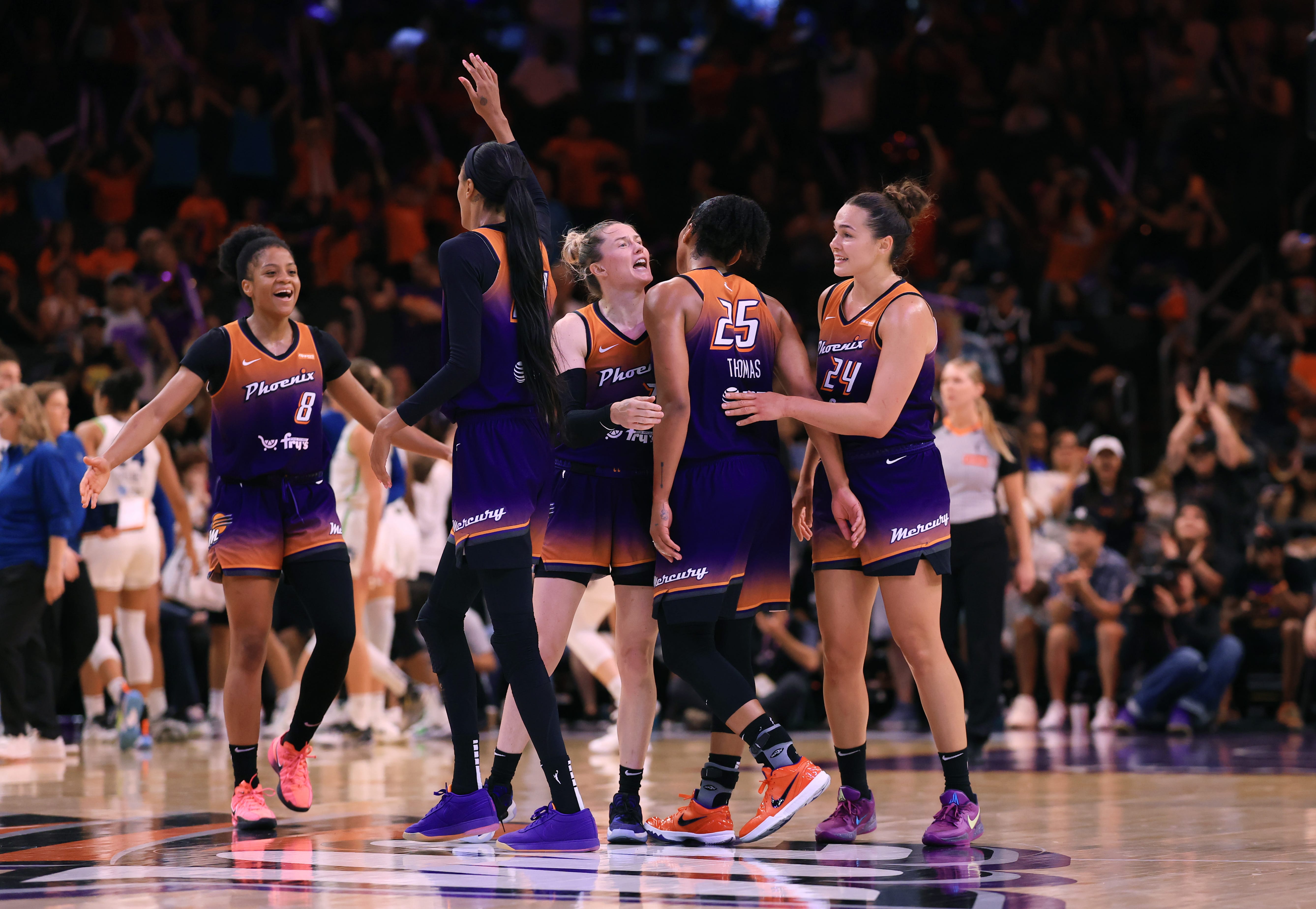 Mercury players celebrate a win over the Minnesota Lynx