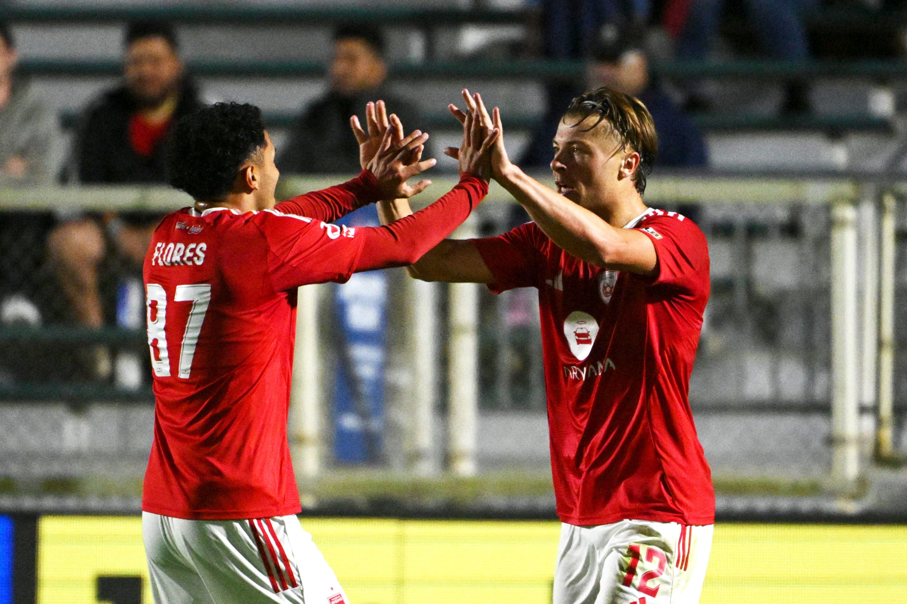 Phoenix Rising players Charlie Dennis and Daniel Flores celebrate in North Carolina