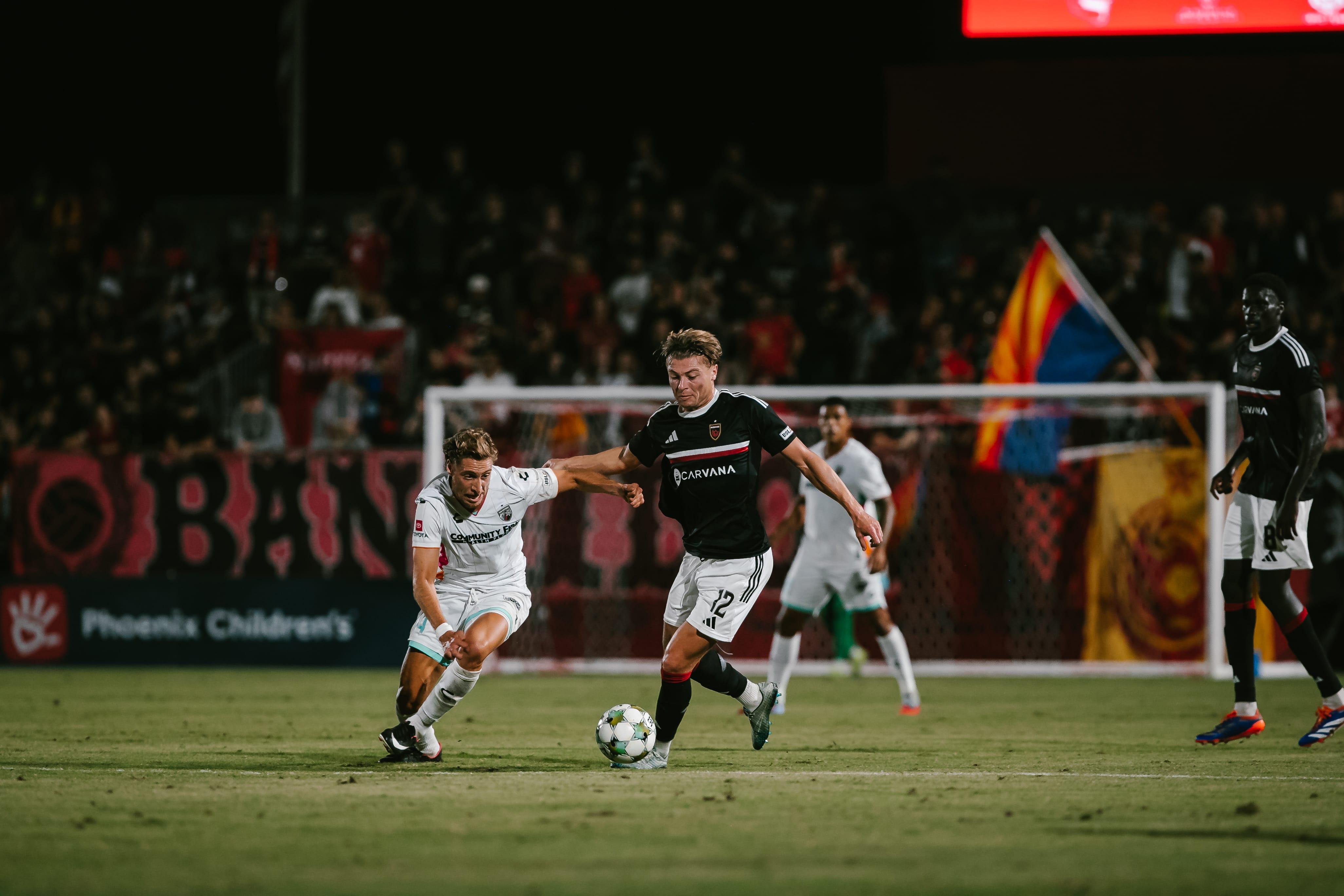 Charlie Dennis runs with the ball at his feet against San Antonio FC. Image: Phoenix Rising / Ashley Orellana
