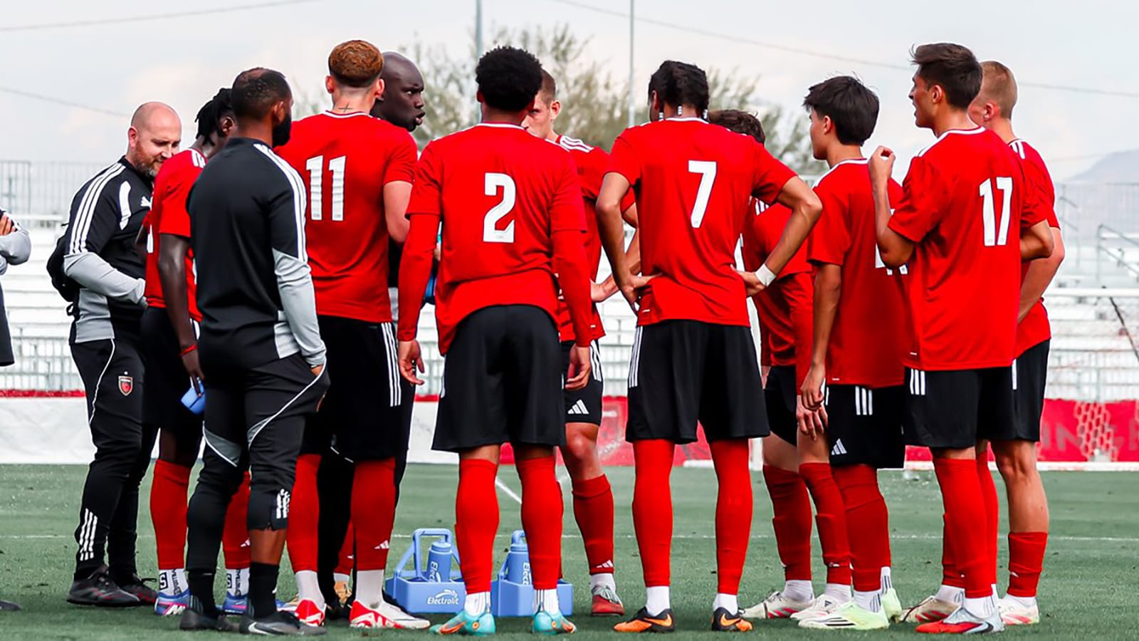 Phoenix Rising players stand in a huddle during training