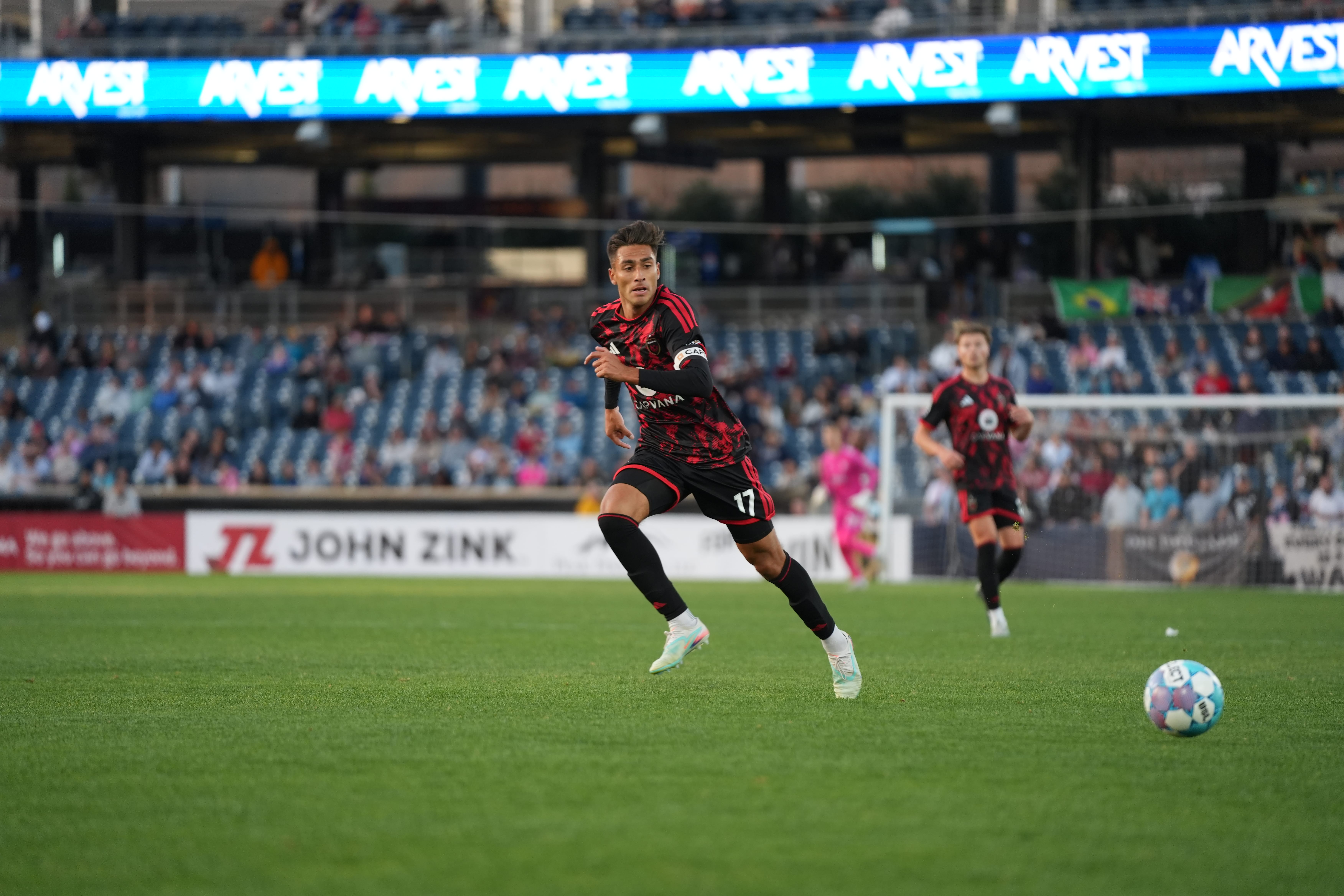 Phoenix Rising midfielder JP Scearce looks at the ball.