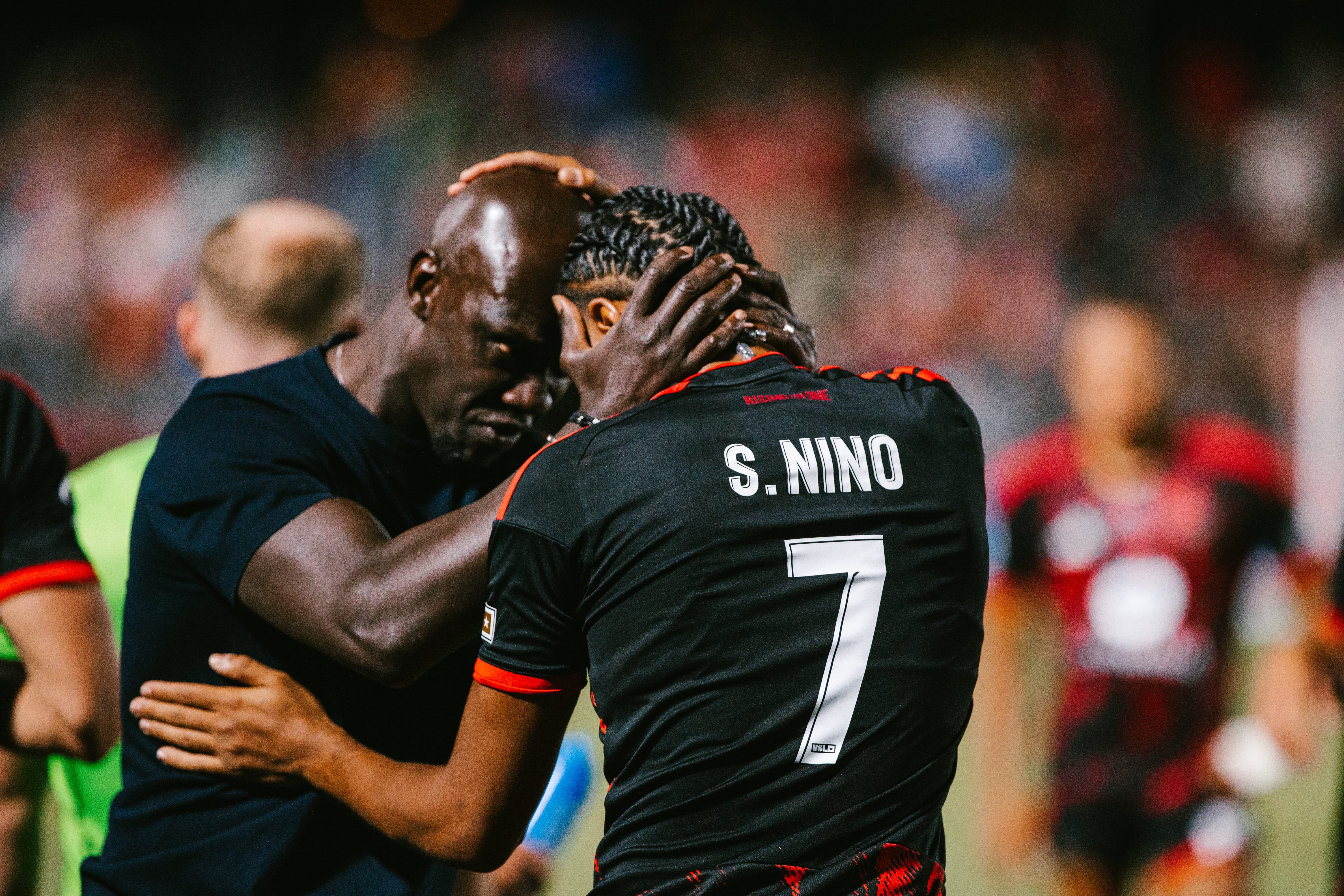 Pa-Modou Kah holds striker Ihsan Sacko in an embrace after Phoenix Rising's 3-0 victory over New Mexico United.