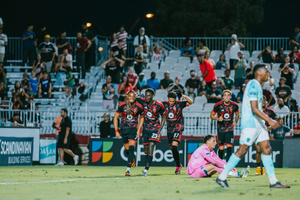 Four Phoenix Rising players celebrate a goal against Monterey Bay FC. Image: Ashley Orellana / Phoenix Rising FC
