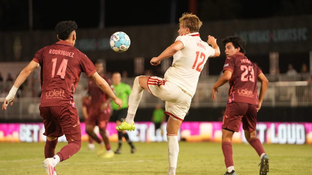 Charlie Dennis of Phoenix Rising challenges for the ball against Las Vegas Lights FC