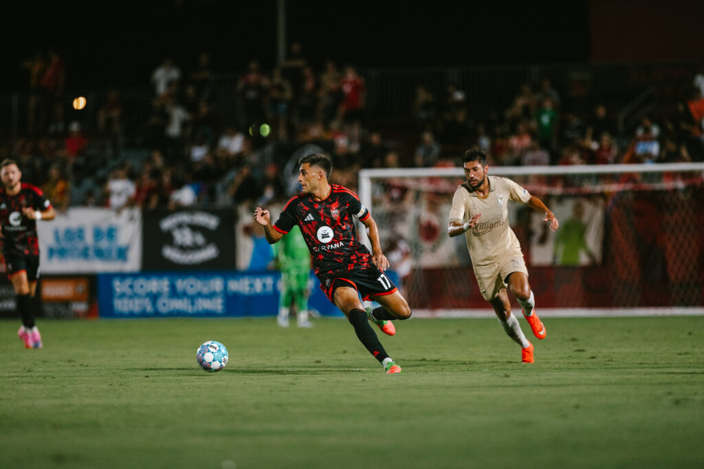 JP Scearce of Phoenix Rising dribbles the ball against FC Tulsa