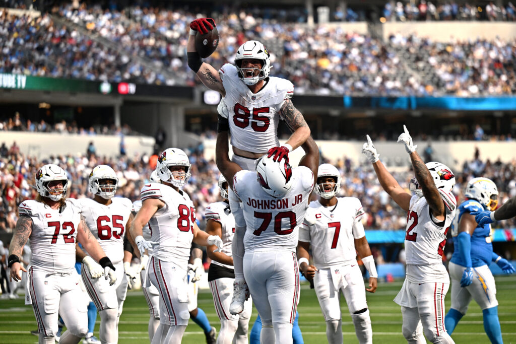 Sep 13, 2026; Inglewood, California, USA; Arizona Cardinals tight end Trey McBride (85) is lifted in the air by. offensive line Paris Johnson Jr. (70) after catching a touchdown against the Los Angeles Chargers during the fourth quarter at SoFi Stadium. Mandatory Credit: William Liang-Imagn Images