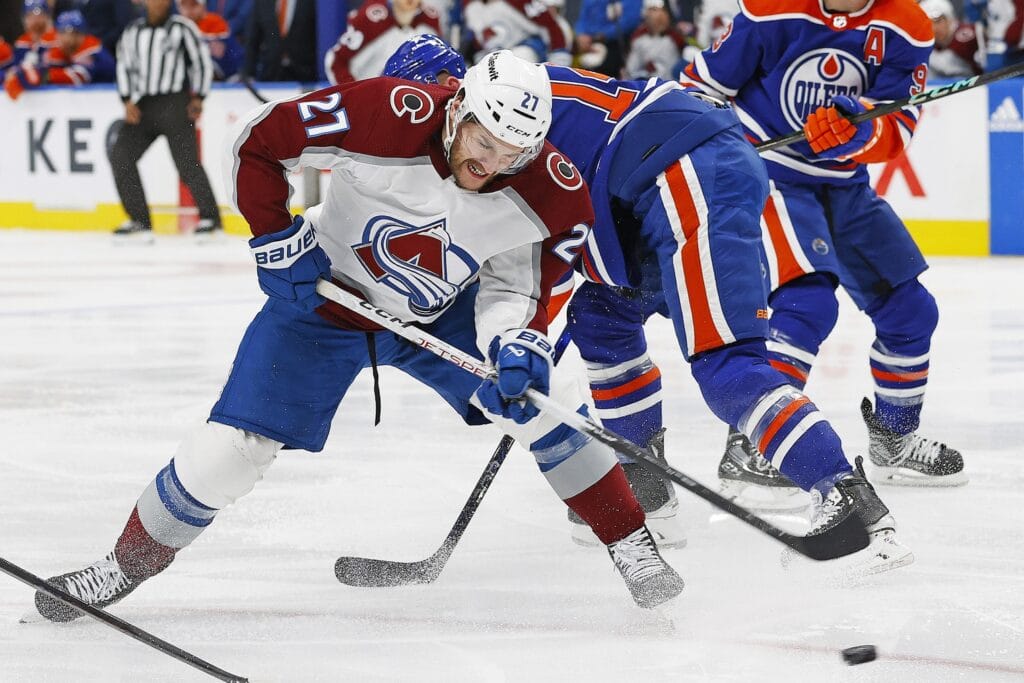 Colorado Avalanche forward Jonathan Drouin battles for a puck.