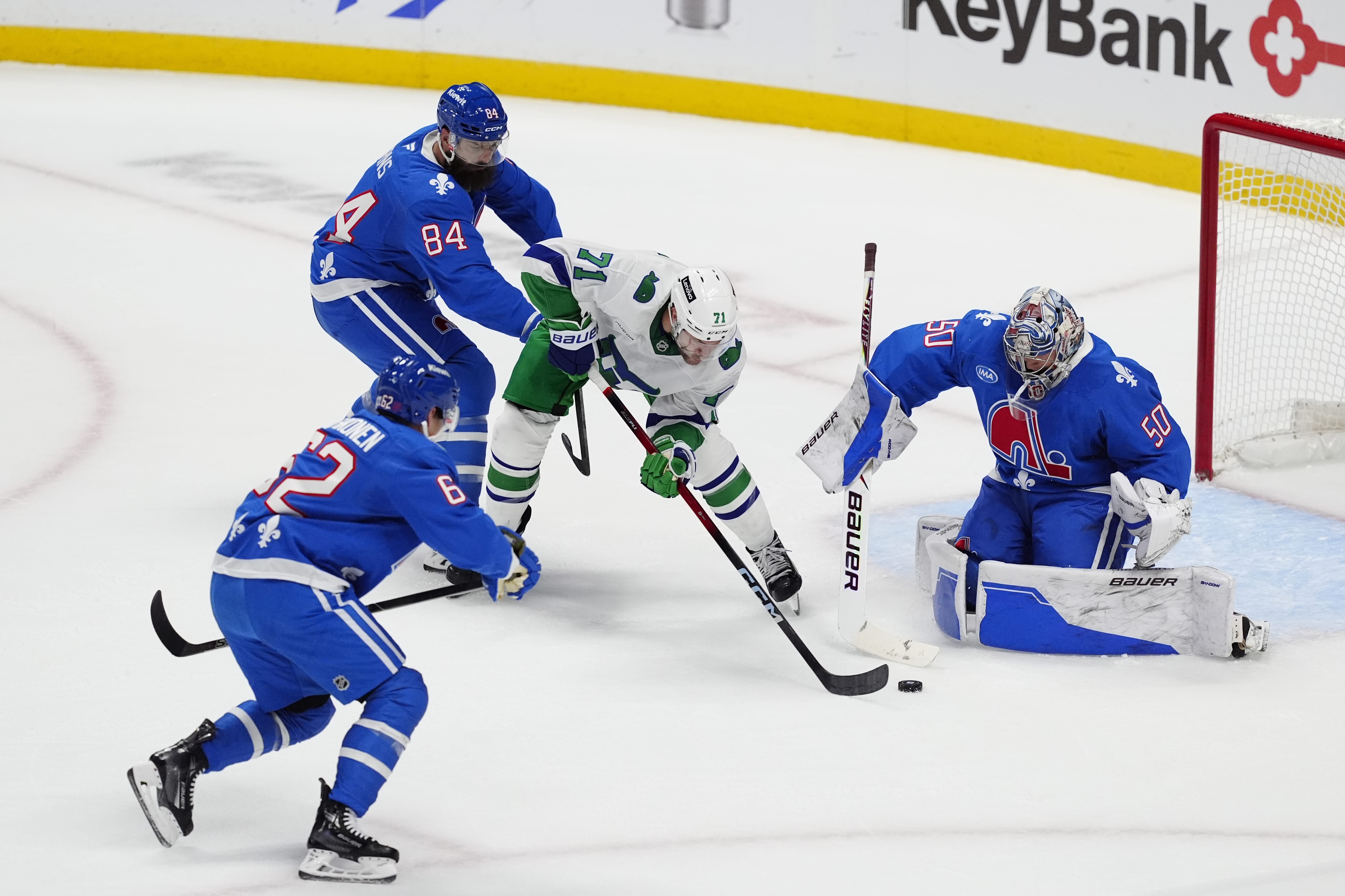 Oct 23, 2025; Denver, Colorado, USA; Colorado Avalanche goaltender Trent Miner (50) and defenseman Brent Burns (84) and left wing Artturi Lehkonen (62) defend on Carolina Hurricanes left wing Taylor Hall (71) in the third period at Ball Arena. Mandatory Credit: Ron Chenoy-Imagn Images