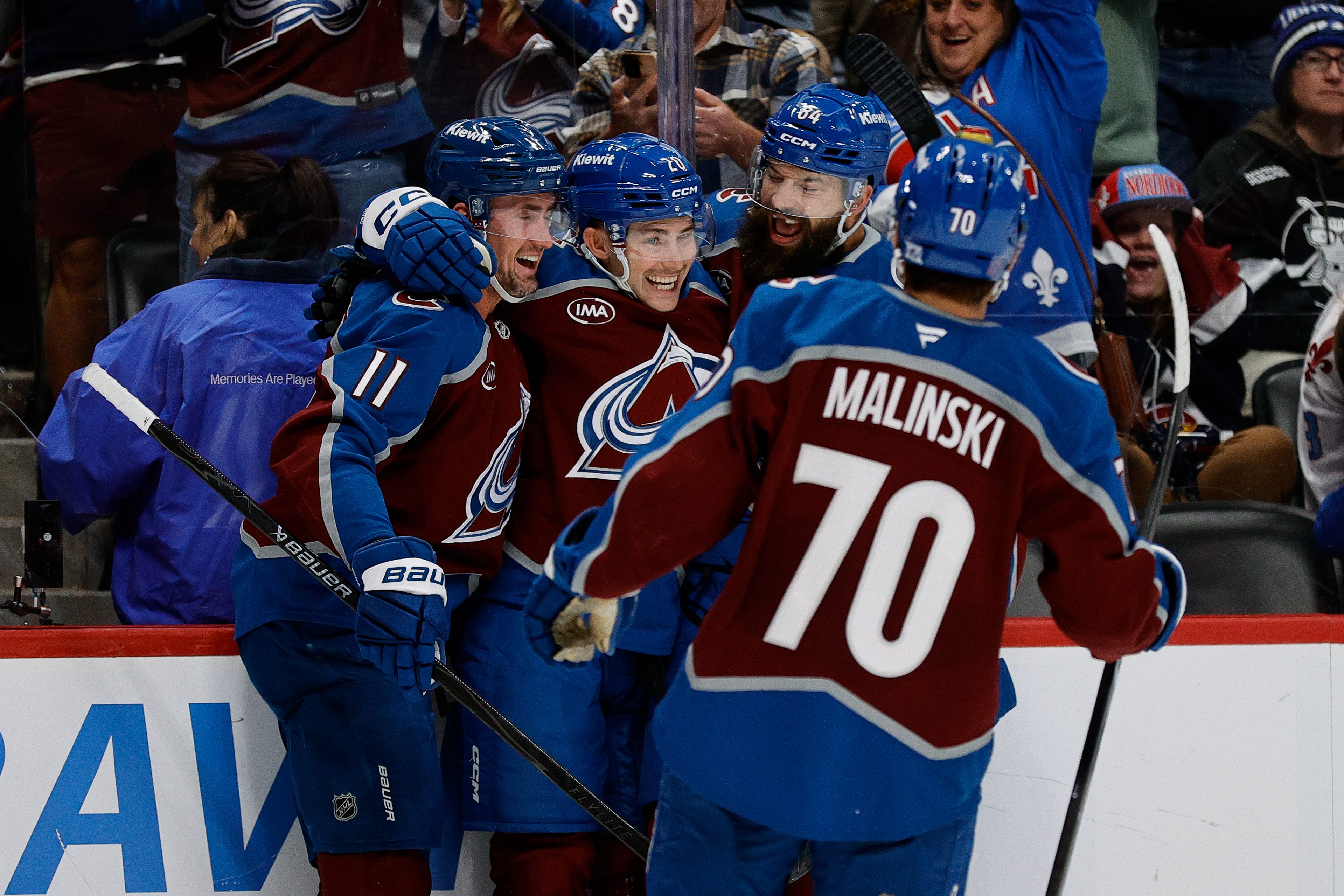 Colorado Avalanche center Ross Colton (20) celebrates his goal with center Brock Nelson (11) and defenseman Brent Burns (84) and defenseman Sam Malinski (70) in the second period against the Tampa Bay Lightning at Ball Arena. Mandatory Credit: Isaiah J. Downing-Imagn Images
