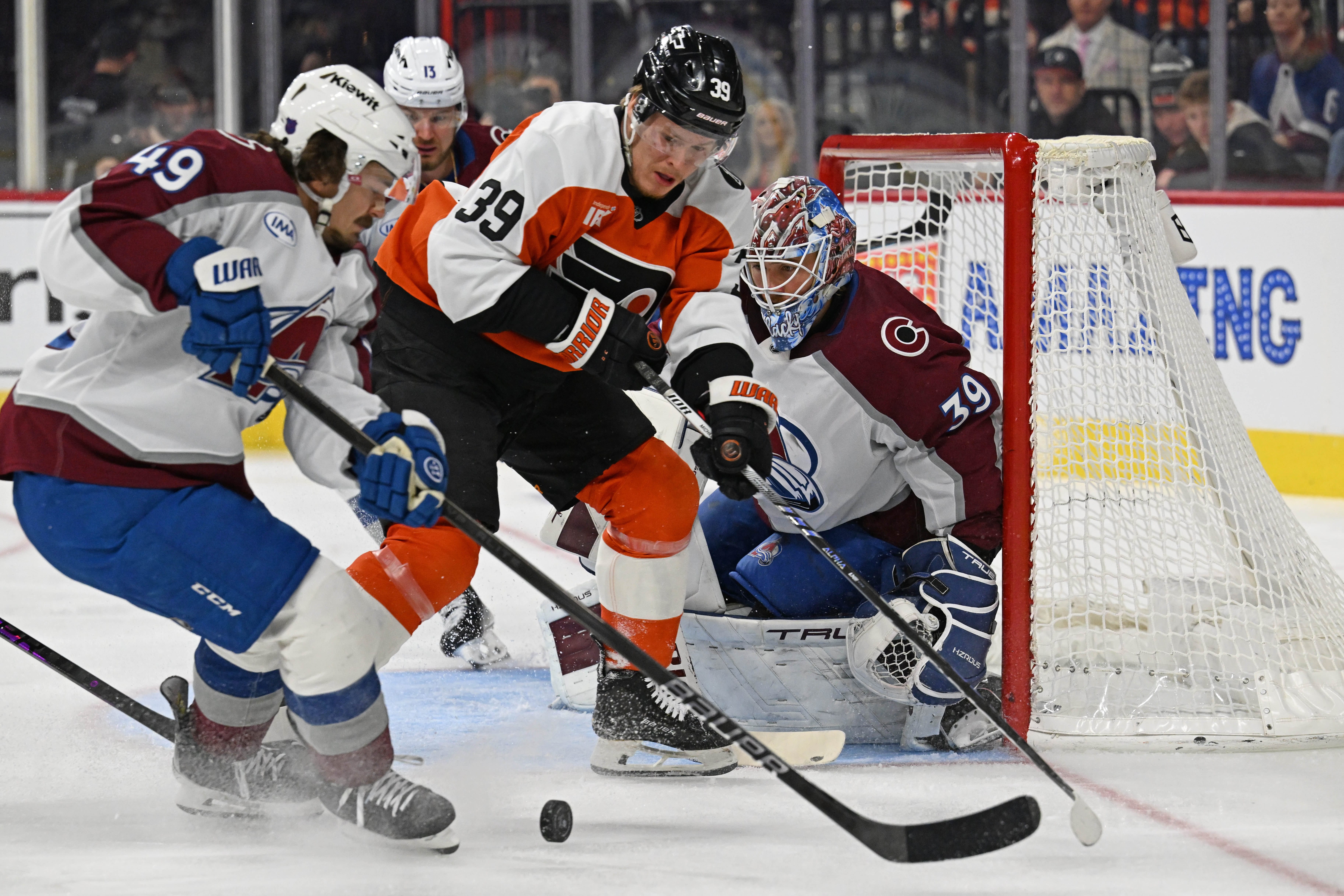 Colorado Avalanche defenseman Samuel Girard (49) and Philadelphia Flyers right wing Matvei Michkov (39) battle for the puck in front of goaltender Mackenzie Blackwood (39) during the first period at Xfinity Mobile Arena. Mandatory Credit: Eric Hartline-Imagn Images