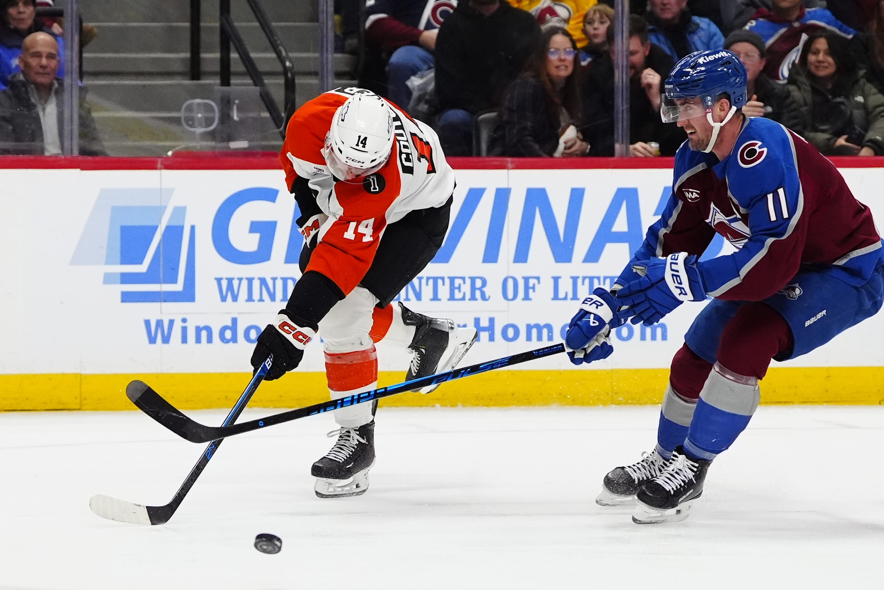Colorado Avalanche center Brock Nelson (11) stops the shot on goal by Philadelphia Flyers center Sean Couturier (14) in the third period at Ball Arena. Mandatory Credit: Ron Chenoy-Imagn
