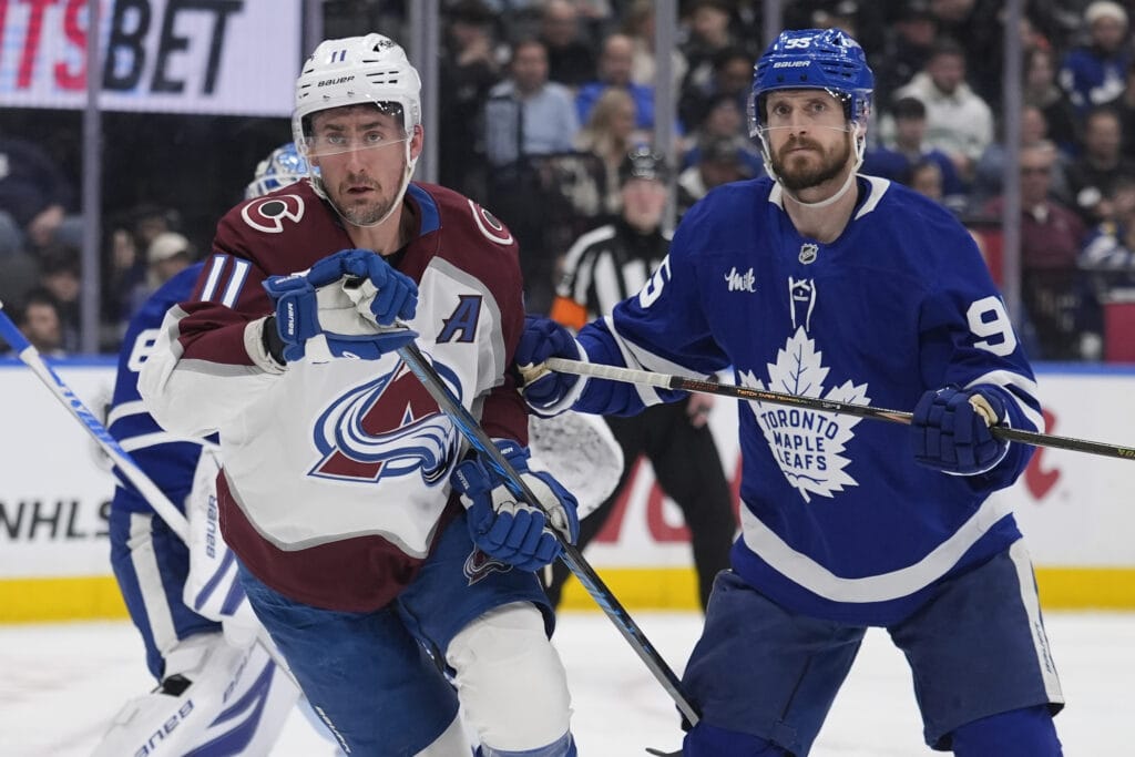 Colorado Avalanche forward Brock Nelson (11) and Toronto Maple Leafs defenseman Oliver Ekman-Larsson (95) look for the puck during the second period at Scotiabank Arena. Mandatory Credit: John E. Sokolowski-Imagn Images